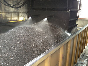 Machines contour and spray coal when loading on rail cars to prevent dust releases.