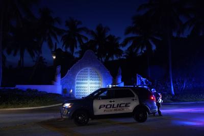 Police stand outside an entrance to former President Donald Trump's Mar-a-Lago estate on Aug. 8, 2022, in Palm Beach, Fla.