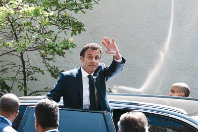 French President and centrist candidate Emmanuel Macron waves from his car after casting his vote in Le Touquet, northern France, Sunday, April 24, 2022. France began voting in a presidential runoff election Sunday with repercussions for Europe's future...