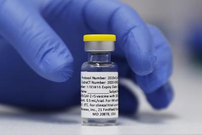 A vial of the Phase 3 Novavax coronavirus vaccine is prepared for use in a trial at St. George's University hospital in London.