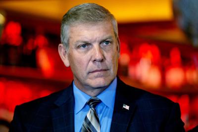 Rep. Barry Loudermilk listens to a speaker at a press conference.