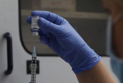 A vial of the Phase 3 Novavax coronavirus vaccine is seen ready for use in the trial at St. George's University hospital in London, Oct. 7, 2020.