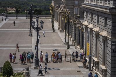 People queue to buy tickets to enter the Royal Palace during a hot and sunny day in Madrid, Spain, on July 18, 2022.