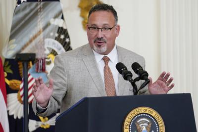 Education Secretary Miguel Cardona speaks in the East Room of the White House.