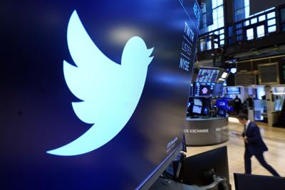 The logo for Twitter appears above a trading post on the floor of the New York Stock Exchange.