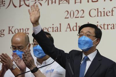 John Lee  waves  after   his election victory in Hong Kong on May 8, 2022.