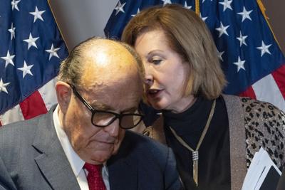 Rudy Giuliani listens to Sidney Powell, both lawyers for then-President Donald Trump, during a news conference at the RNC headquarters, Thursday, Nov. 19, 2020, in Washington.