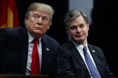 FBI Director Christopher Wray (right), shown in 2017, has certainly helped Donald Trump politically, writes Rich Lowry. It has put Trump front-and-center again. It has made it easy for him to portray himself as an embattled victim.