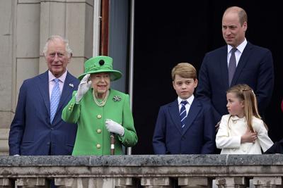 Queen Elizabeth II waves from the balcony during the Platinum Jubilee Pageant outside Buckingham Palace in London.