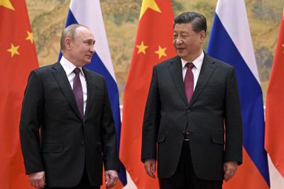 Chinese President Xi Jinping and Russian President Vladimir Putin talk during their meeting in Beijing on Feb. 4, 2022.