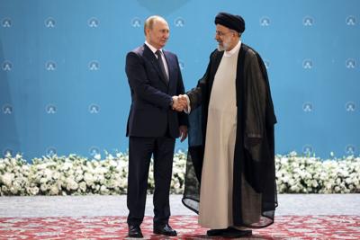 Russian President Vladimir Putin, left, and Iranian President Ebrahim Raisi shake hands prior to their talks at the Saadabad palace, in Tehran, Iran, Tuesday, July 19, 2022. (Sergei Savostyanov, Sputnik, Kremlin Pool Photo via AP)