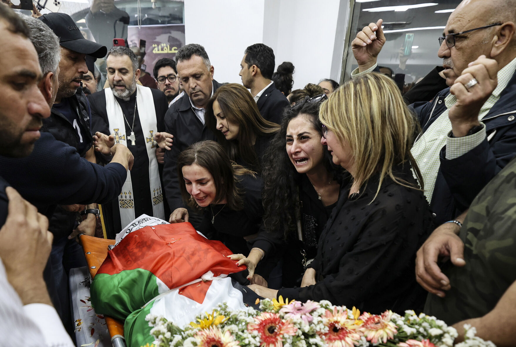 The Palestinian flag-draped body of Shireen Abu Akleh was brought to the Al-Jazeera office in the West Bank city of Ramallah, Wednesday, May 11, 2022.