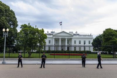 Secret Service agents stand watch outside the White House.