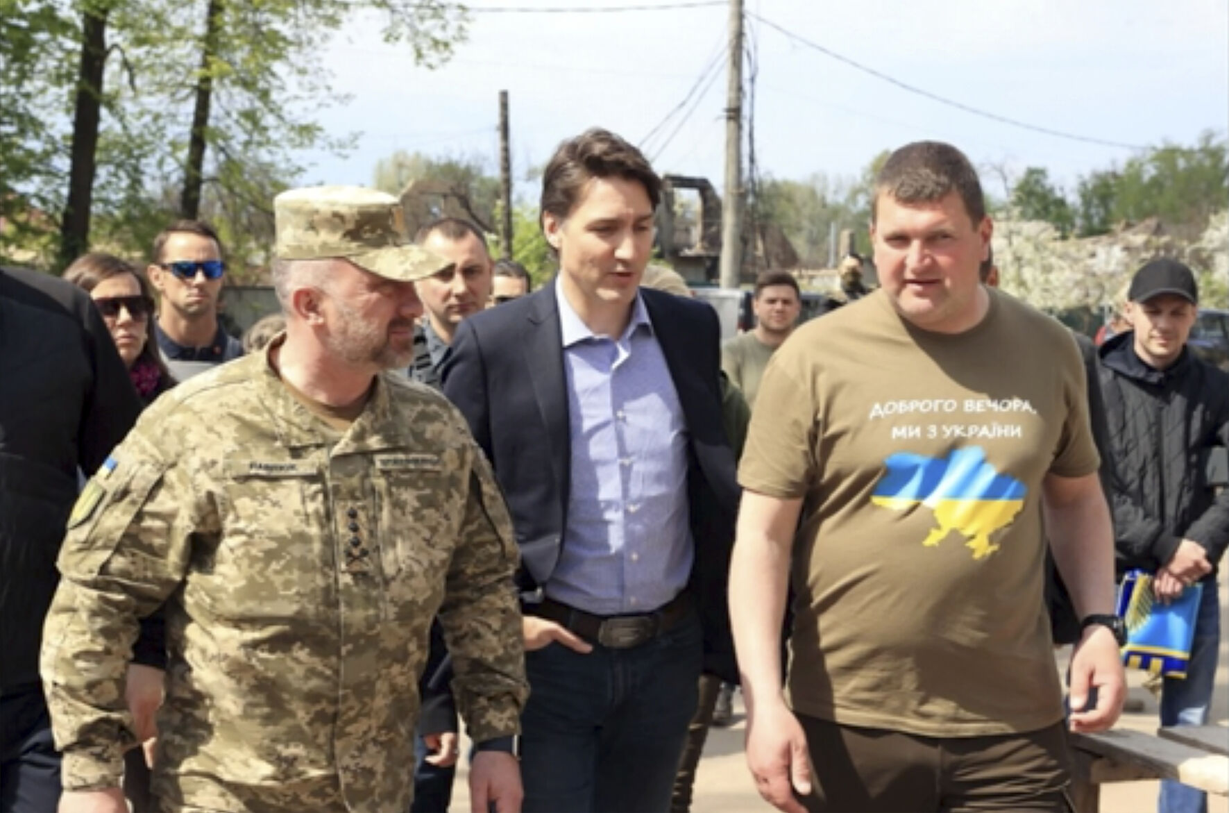 This image provided by the Irpin Mayor's Office shows Canadian Prime Minister Justin Trudeau walking with mayor Oleksandr Markushyn, right, in Irpin, Ukraine, Sunday, May 8, 2022.