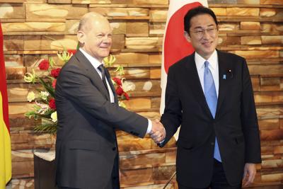 German Chancellor Oraf Scholz shakes hands with Japanese Prime Minister Fumio Kishida prior to their talks  in Tokyo on April 28, 2022.
