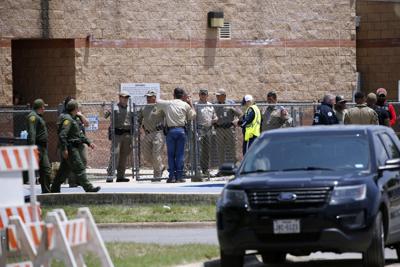 Law enforcement and other first responders gather outside Robb Elementary School following a shooting, on May 24, 2022, in Uvalde, Texas.