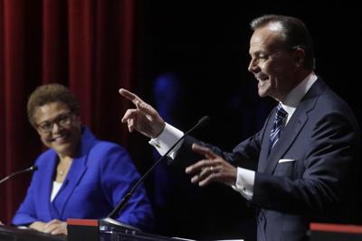 Rep. Karen Bass, left, and businessperson Rick Caruso during a mayoral debate, Tuesday, March 22, 2022, in Los Angeles.