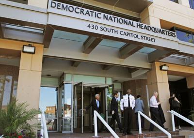 People stand outside the Democratic National Committee headquarters in Washington on June 14, 2016.