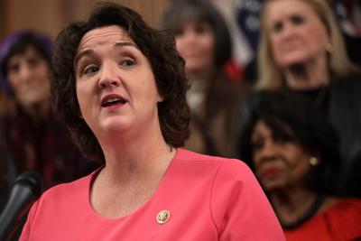 Rep. Katie Porter speaks as other House Democrats listen during an event at the Rayburn Room of the U.S. Capitol.
