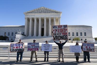 Gun rights advocates rally outside the U.S. Supreme Court in Washington, Wednesday, Nov. 3, 2021.