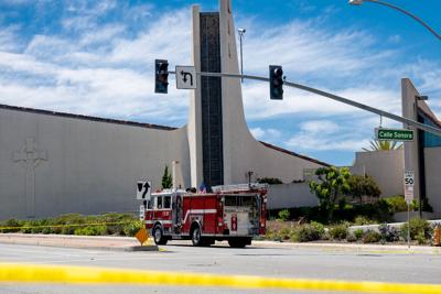 A firetruck is seen outside the Geneva Presbyterian Church in Laguna Woods, Calif., on Sunday, May 15, 2022 after a fatal shooting.