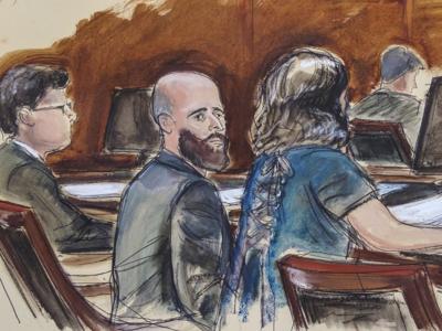 In this courtroom sketch, Joshua Schulte, center, is seated at the defense table flanked by his attorneys during jury deliberations, Wednesday March 4, 2020, in New York.