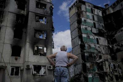 A man stands looking at a building destroyed during attacks, in Borodyanka, on the outskirts of Kyiv, on June 4, 2022.