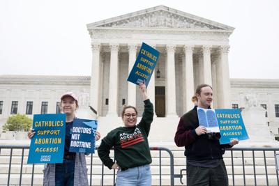 People demonstrate outside the U.S. Supreme Court in reaction to news that the court may be poised to overturn Roe v. Wade, May 3, 2022.
