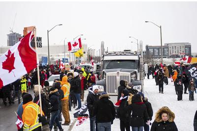 Protestors show their support for the "freedom convoy" of truck drivers who are making their way to Ottawa to protest against Covid-19 vaccine mandates by the Canadian government on Jan. 27, 2022, in Vaughan.