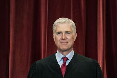 Associate Justice Neil Gorsuch stands during a group photo at the Supreme Court in Washington, April 23, 2021.