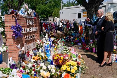 President Joe Biden and first lady Jill Biden visit a memorial at Robb Elementary School to pay their respects to the victims of the mass shooting, Sunday, May 29, 2022, in Uvalde, Texas.
