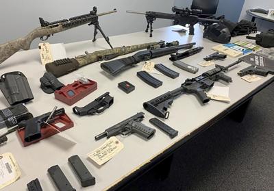 An arsenal of guns seized from a North California man in May 2022.