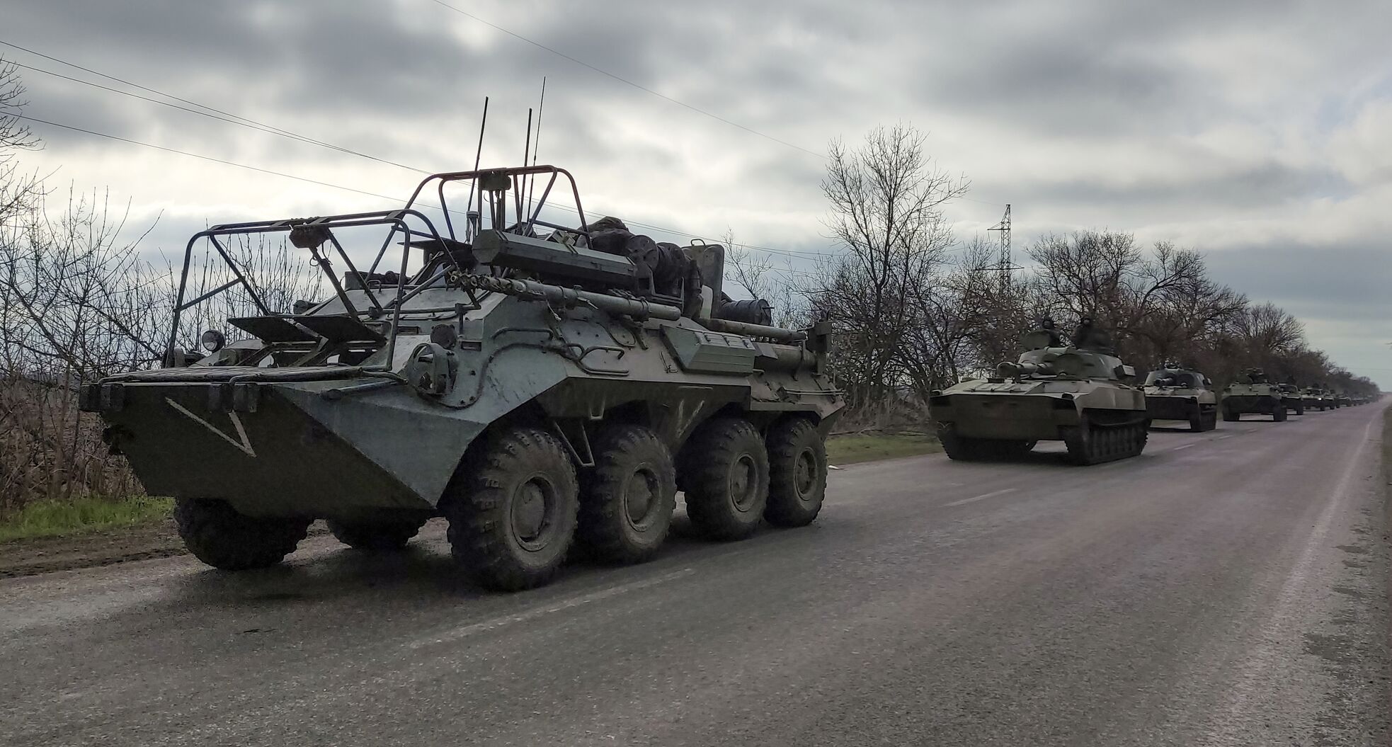 A Russian military convoy moves on a highway in an area controlled by Russian-backed separatist forces near Mariupol, Ukraine, on April 16, 2022.