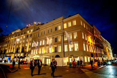 People walk past the Bayerischer Hof hotel in Munich, Germany, Friday, Feb. 18, 2022, on the first day of the Munich Security Conference.