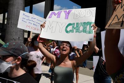 Abortion-rights supporters hold up signs during a rally on May 14, 2022 in Fort Lauderdale, Florida.
