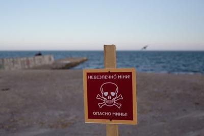 A sign that reads "Caution: mines" is pictured on the beach on April 25, 2022 in Odesa, Ukraine.