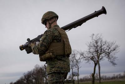 A U.S. Marine carries a Stinger air defense missile launcher during training at the Capu Midia Surface to Air Firing Range, on the Black Sea coast in Romania.