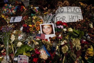 A photo of Heather Heyer, who was killed during a white nationalist rally, sits on the ground at a memorial at the Paramount Theater in Charlottesville, Va., on Aug. 16, 2017.