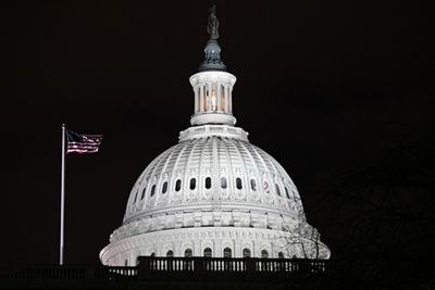 WASHINGTON, DC - JANUARY 06: A U.S. flag flies over the grounds of the U.S. Capitol on January 06, 2021 in Washington, DC. A pro-Trump mob stormed the Capitol earlier, breaking windows and clashing with police officers. Trump supporters gathered in the ...