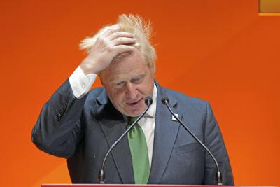 British Prime Minister Boris Johnson adjusts his hair as he speaks  in Birmingham, England, on July 28, 2022.