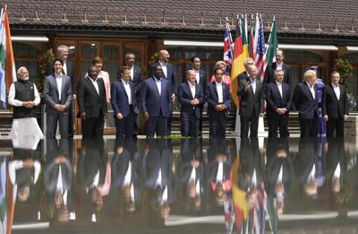 U.S. President Joe Biden, front fourth right, waves as he poses with G7 leaders and Outreach guests for an official group photo at Castle Elmau in Kruen, near Garmisch-Partenkirchen, Germany, on Monday, June 27, 2022. The Group of Seven leading economic...