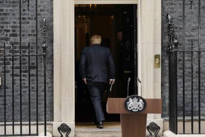 Prime Minister Boris Johnson enters 10 Downing Street, after reading a statement in London, Thursday, July 7, 2022.