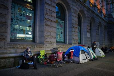 People camp out overnight in line outside a Service Canada passport office in Vancouver, on Wednesday, June 22, 2022.