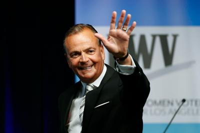 Businessman Rick Caruso waves at the start of a mayoral debate at the Student Union Theater on the California State University, Los Angeles campus on Sunday, May 1, 2022.