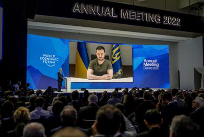 Ukrainian President Volodymyr Zelenskyy displayed on a screen as he addresses the audience from Kyiv on a screen during the World Economic Forum in Davos, Switzerland, Monday, May 23, 2022. The annual meeting of the World Economic Forum is taking place ...