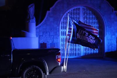 A supporter of former President Donald Trump drives past the Mar-a-Lago estate, Monday, Aug. 8, 2022, in Palm Beach, Fla.