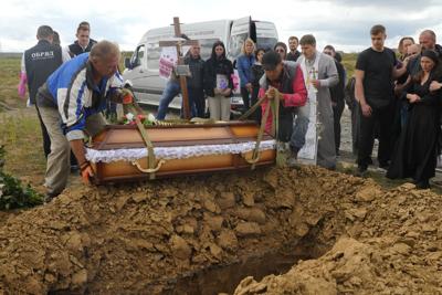 Men lower the coffin of Liza, a 4-year-old girl killed by Russian attack, during a funeral   in Vinnytsia, Ukraine, on July 17, 2022.