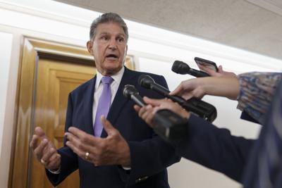 Sen. Joe Manchin talks with reporters on Capitol Hill.