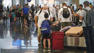 Travelers pass through Salt Lake City International Airport Thursday, June 30, 2022, in Salt Lake City.