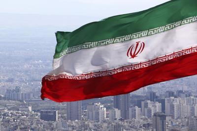 FILE - Iran's national flag waves in Tehran, Iran, March 31, 2020. Iranian media reported on Wednesday July 6, 2022, that the country’s paramilitary Revolutionary Guard has accused the deputy ambassador of the United Kingdom and other foreigners in the ...